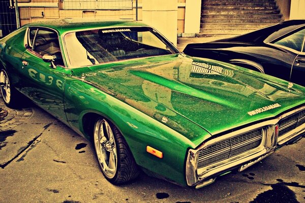 A shiny green car outside the building