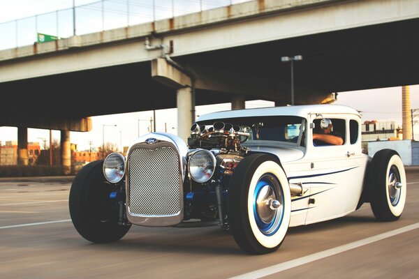 Old model car under the bridge