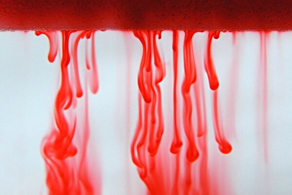 Red paint mixes with water