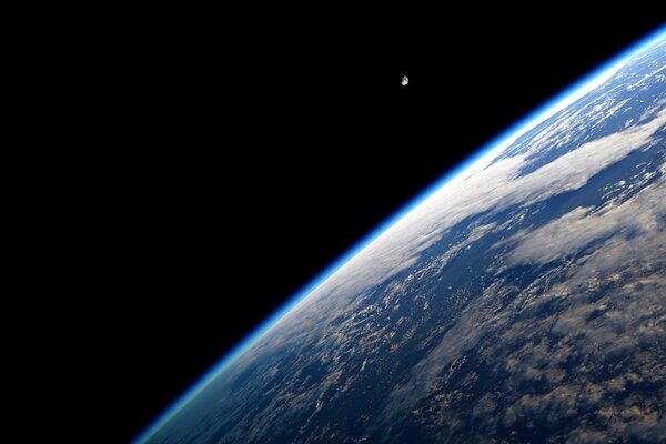 The moon in space above the planet Earth