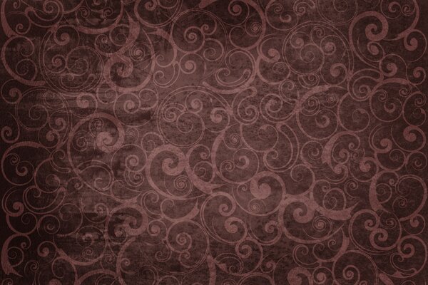 A pattern of spirals and curls on a dark background