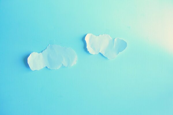 On the blue background of the sky there are clouds cut separately