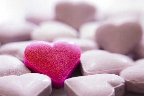 Pink heart on a background of white hearts