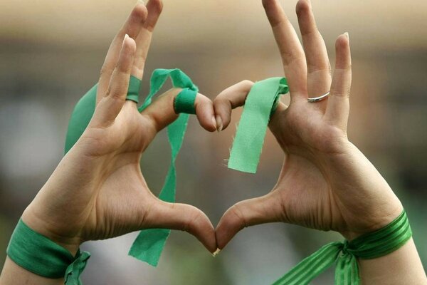 Hands in green ribbons depicting a heart