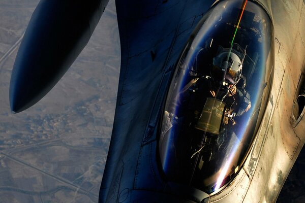 The cabin of an airplane with a military pilot