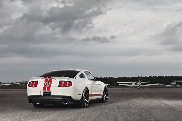 White Ford Mustang on the airplane lane