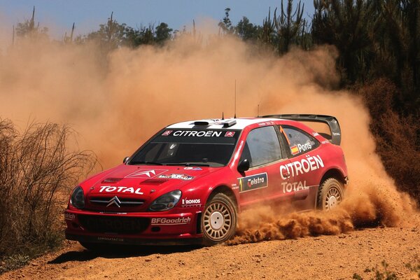 Red citroen on the turn during the rally