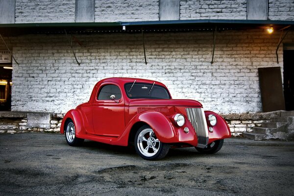 Retro car on the background of a brick building