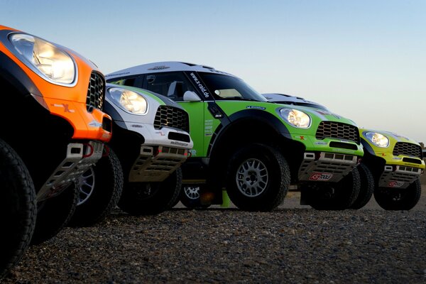 Hoods of cars of different colors close-up side view