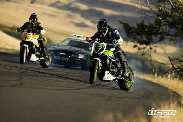 Racing motorcycles green and yellow on the road behind the police