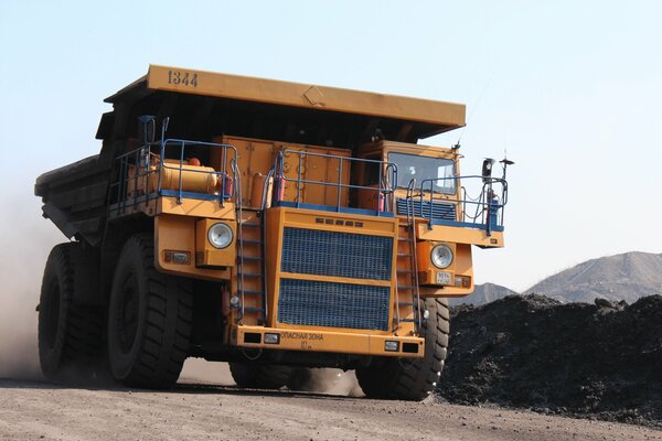 Heavy truck moving on dusty road