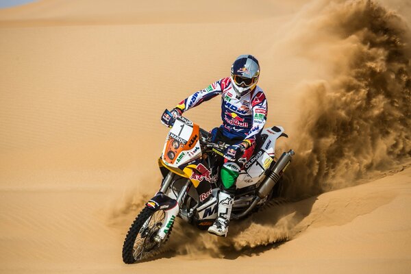 Motorcycle red bull. Racer on the sand