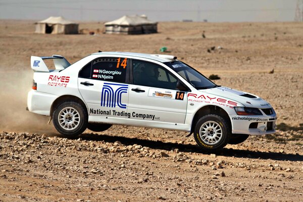 White mitsubishi at a rally in the desert