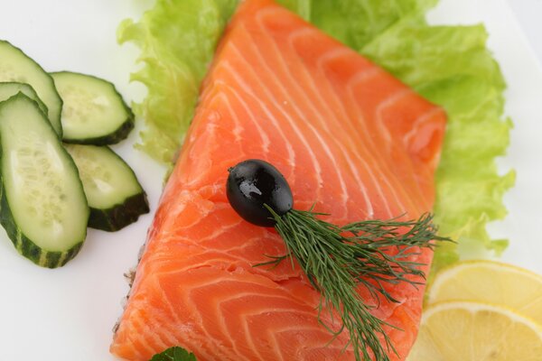 Salmon decoration with cucumbers and olives