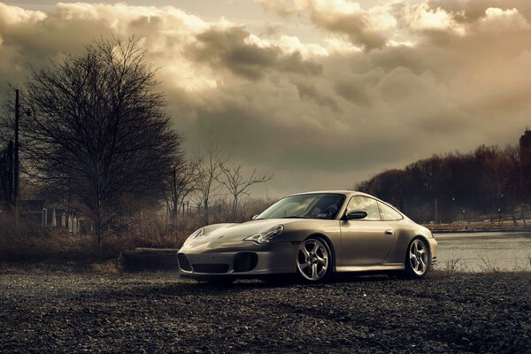 Grey porsche car on a gloomy background