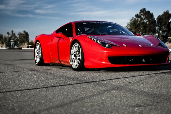 Red Ferrari on a sunny road