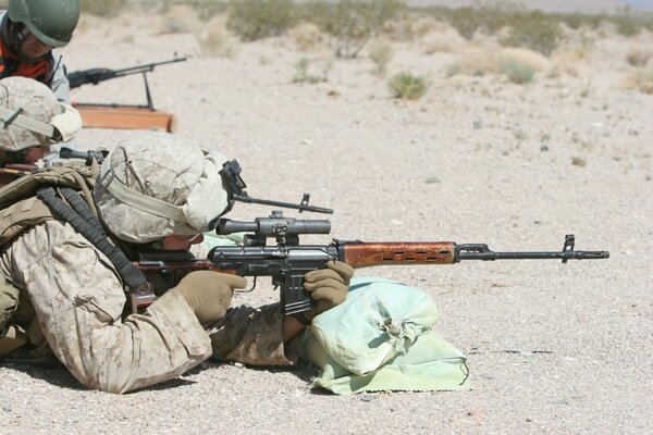 Soldat liegt mit Maschinengewehr am Boden