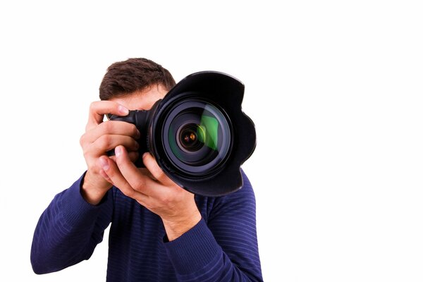 A man in a blue jacket holds a camera