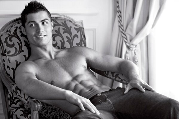 Cristiano Ronaldo with an open torso in a chair