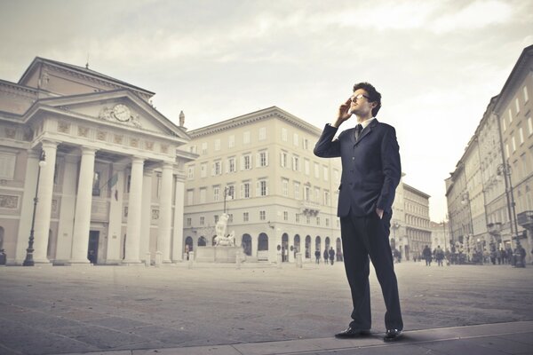 A man in a business suit in the city square