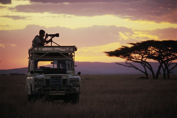 Photographer on the roof of a car in Africa catches a frame