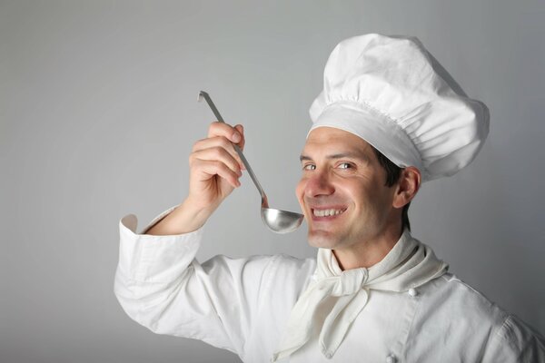 Cook with a ladle on a gray background