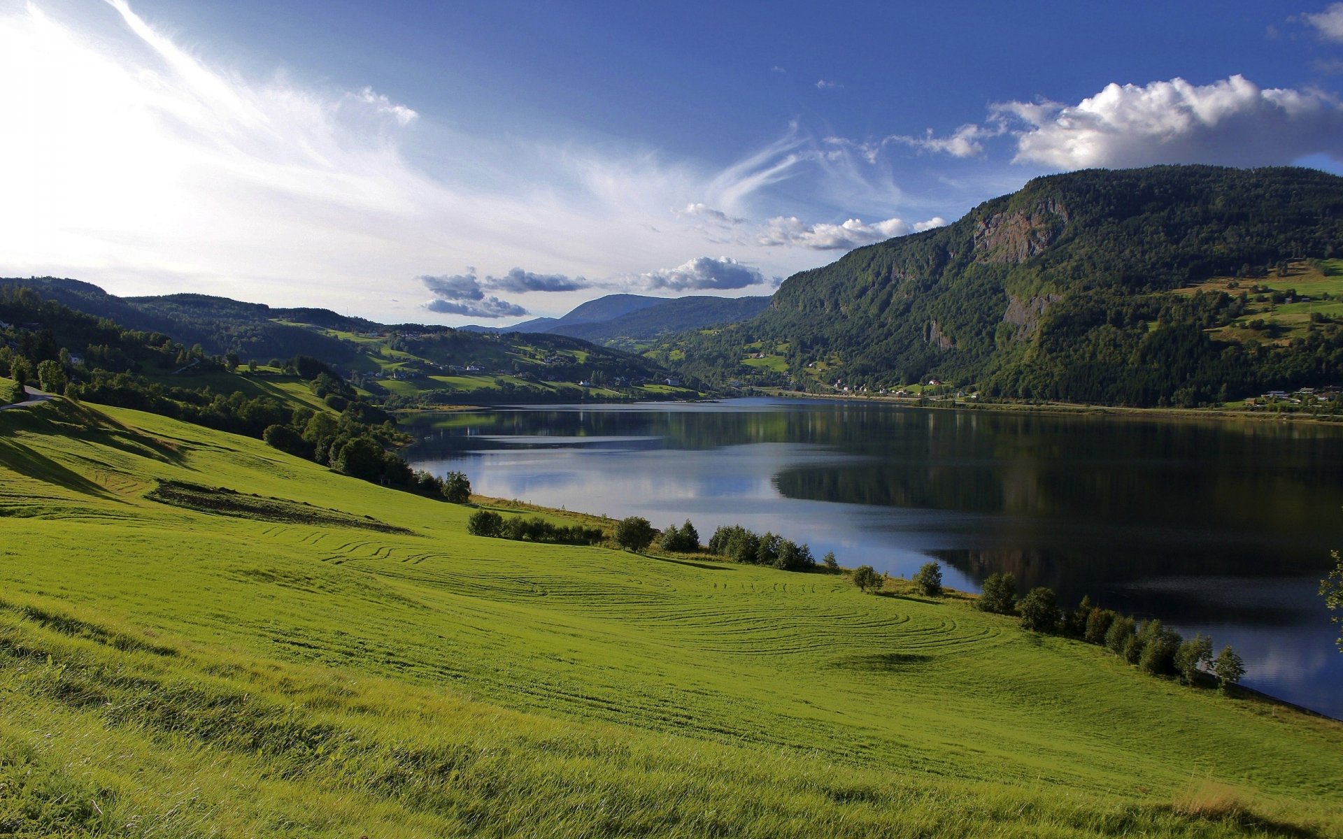 lake water of the field grass green hills mountain summer tree sky clouds nature landscape