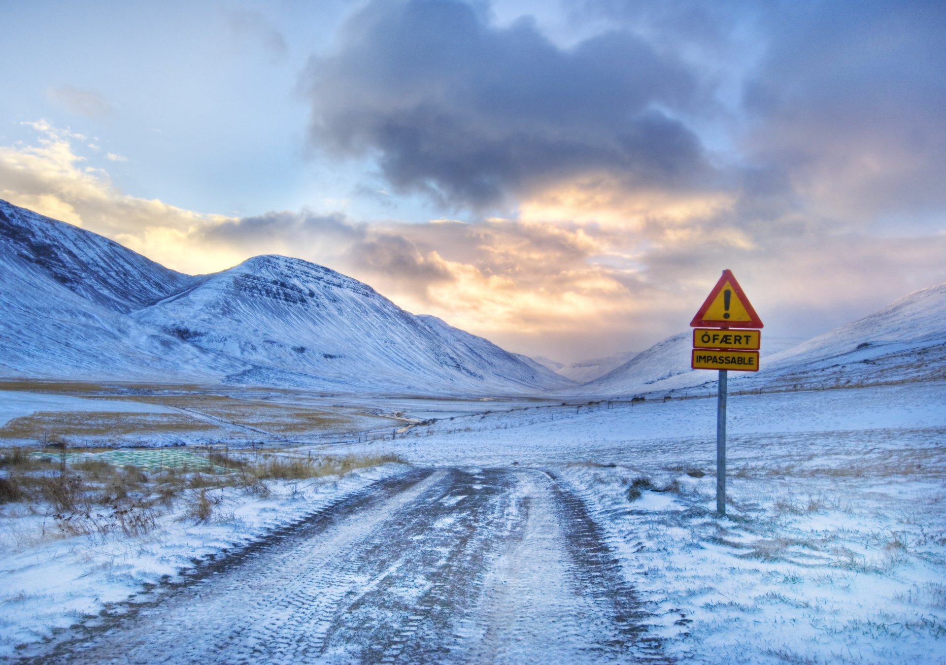 winter road leading to mt. and an exclamation mark