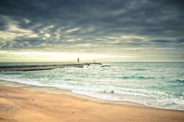 Sandy beach with lighthouses on the sea