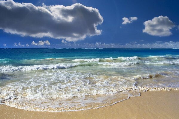 The deep splendor of the azure ocean , the water foamed with waves and a cloudy horizon