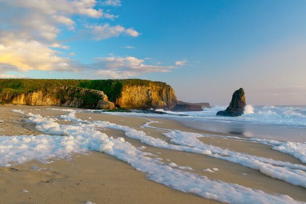 Ocean coast, rocks in foam