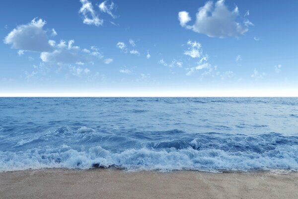 Rough sea with sandy beach and blue sky