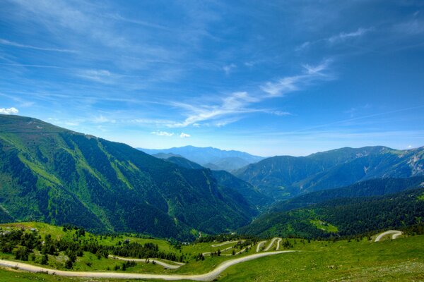 A landscape with a radiant blue sky and rich green grass