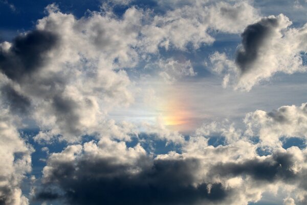 A piece of the rainbow in the clouds in the sky