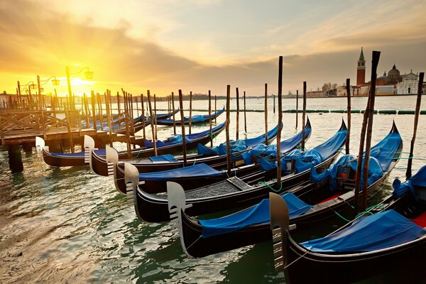 Gondolas on the water in Venice at sunrise