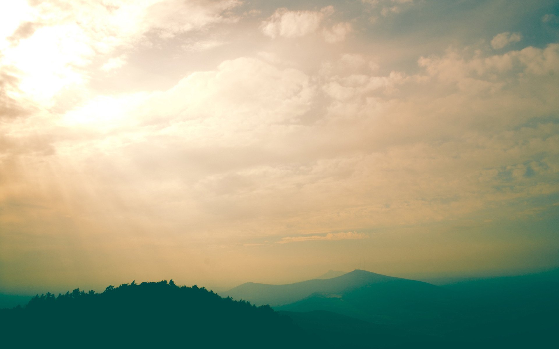 mountains fog haze morning hill landscape sky clouds sky sky view sun lightrays day trees green photo beauty