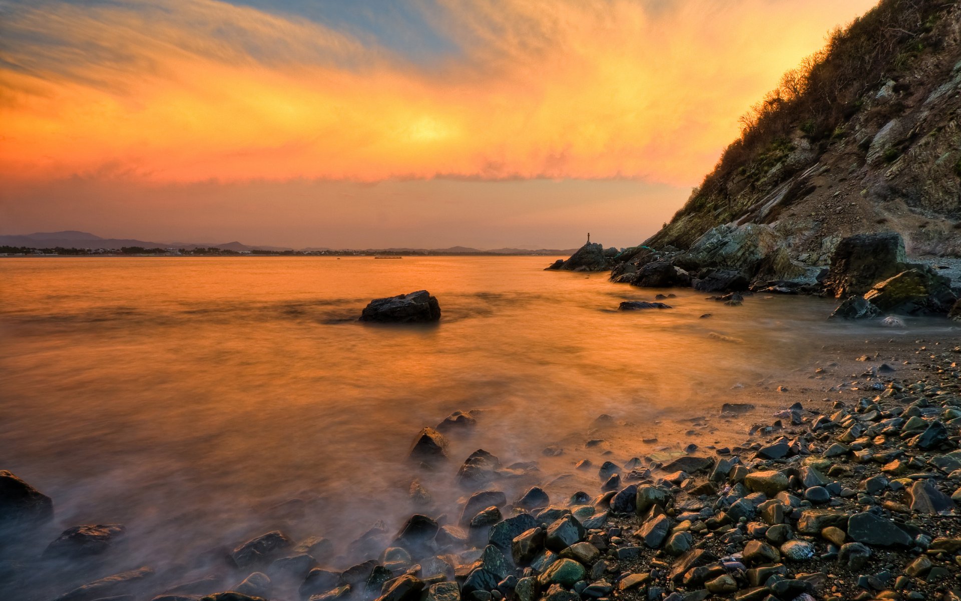 landscape stones pebbles beach rock ocean waves spray sky cloud