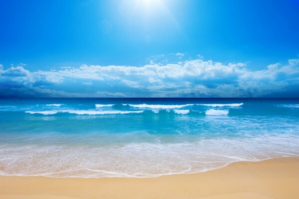 Beach, sea waves and bright sky