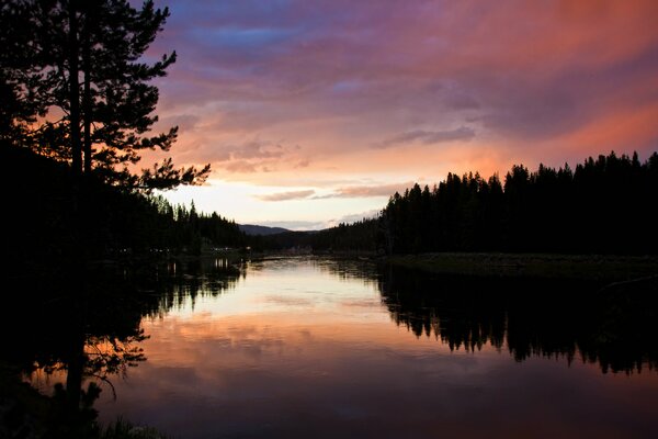 Natural night landscape with highlights of the water surface and sunset sky