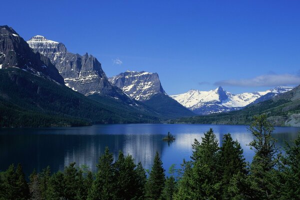 Mirror lake on the background of snow-capped mountains