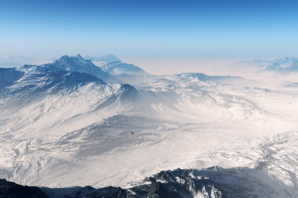 Vista de pájaro de las montañas cubiertas de nieve