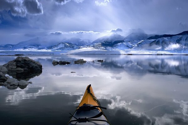 A huge river mountains in the snow on the horizon