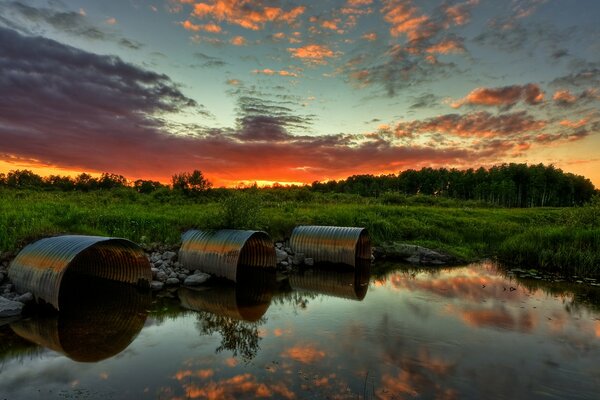 Reflections of lakes with pipes in the sky