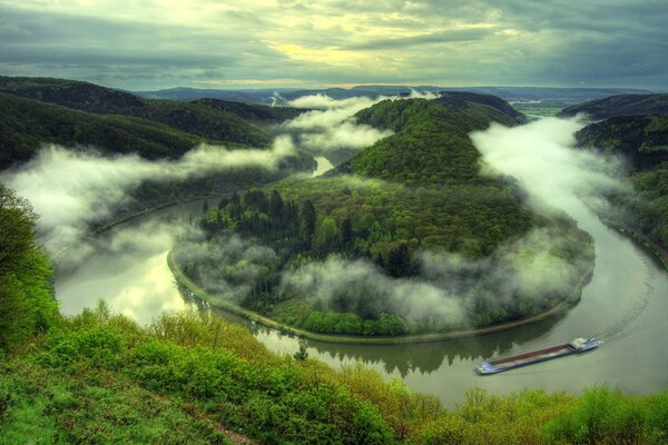 The landscape of the river and the forest and the view of a passing box