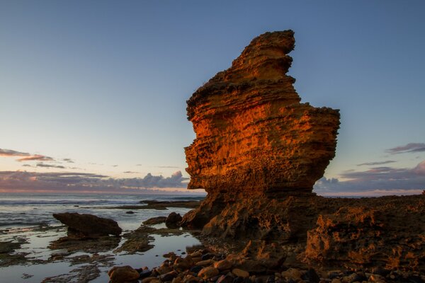 A lonely remnant of a rock on the shore of a silent sea