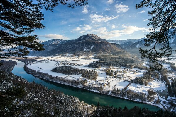 Fiume invernale che scorre lungo le montagne
