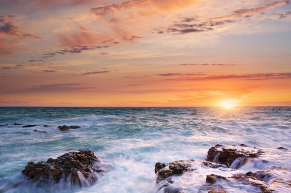Mer coucher de soleil pierres et ciel