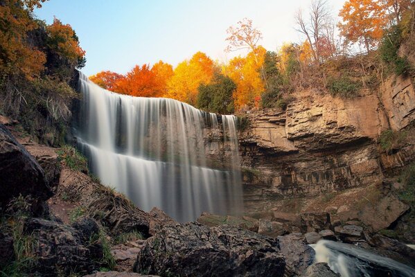 Cascada entre las rocas en otoño