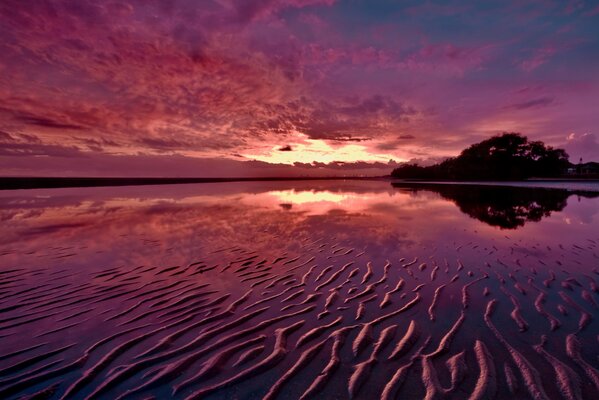 Schöner Sommer Sonnenuntergang mit Reflexion auf dem Wasser