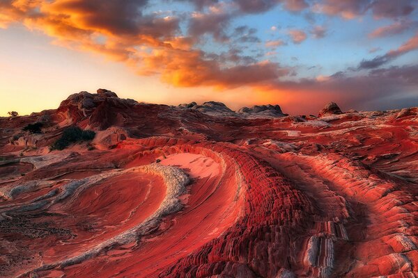 Red wavy mountains against a background of red-blue sky